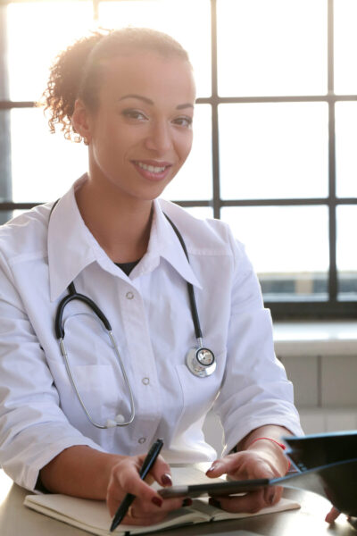 Doctor Medicine. Beautiful doctor by the table